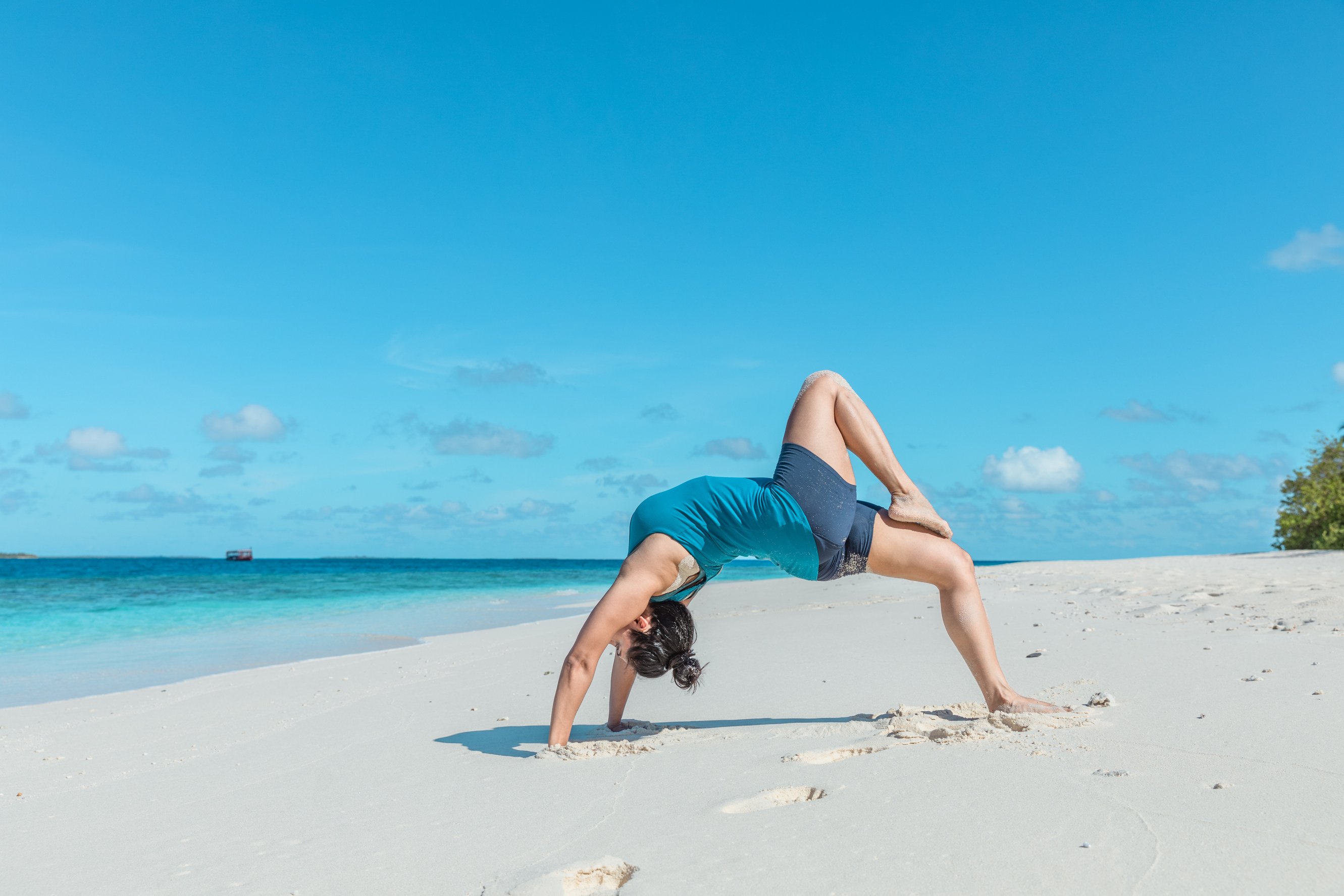 Person Doing Yoga at the Beach