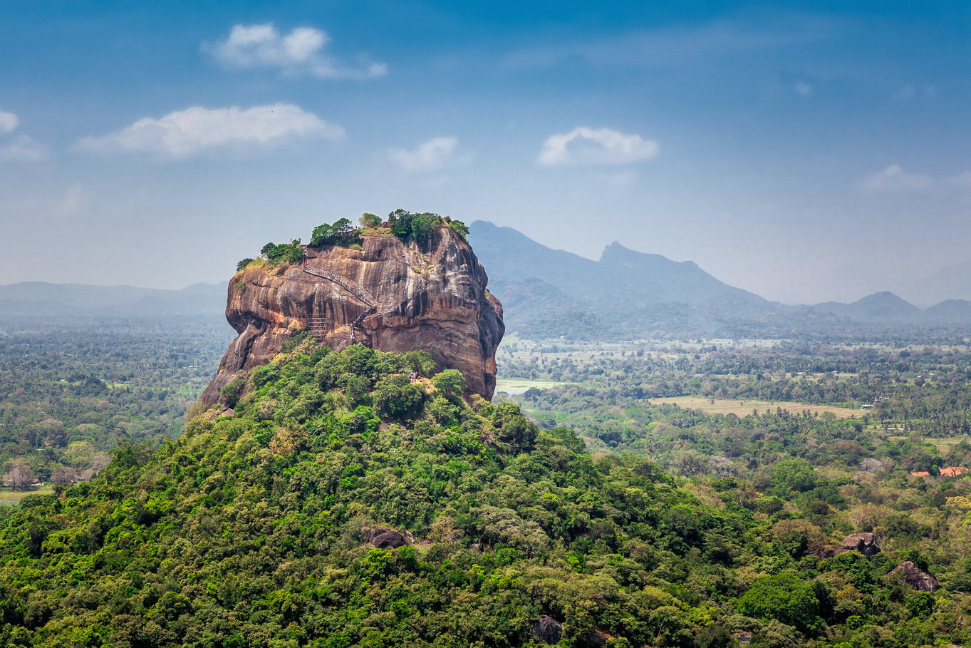 Spectacular view of the Sigiriya Lion rock surrounded by green rich vegetation. Picture taken from Pidurangala mountain in Dambula, Sri Lanka